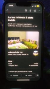a cell phone screen with a picture of a bed at Hôtel mandar itto in Azrou