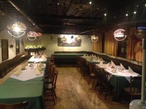 a dining room with green tables and chairs at Gostišče Smuk in Križe