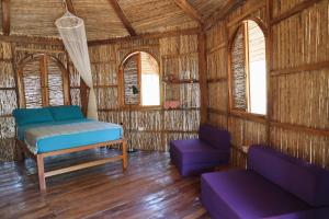a room with a bed and a couch and windows at Adama Eco Farm in Santa Catalina +41 photos