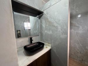 a bathroom with a black sink and a mirror at Cabaña Sueños del Mar in Santa Marta +28 photos