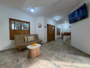 a living room with a couch and a table at Cabaña Sueños del Mar in Santa Marta