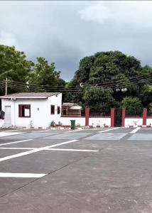 an empty parking lot with a white building at M & A Homes Ilorin in Ilorin