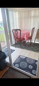 a room with a table and chairs and a table and a table and chairs at Clonvilla Mobile Chalet in Cromponn Bridge