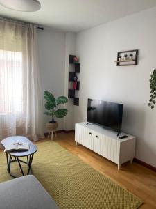 a living room with a flat screen tv on a white cabinet at El Pasaje del Marqués in El Burgo de Osma