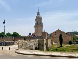 a building with a clock tower in the background at El Pasaje del Marqués in El Burgo de Osma