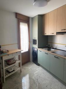 a small kitchen with a sink and a stove at El Pasaje del Marqués in El Burgo de Osma