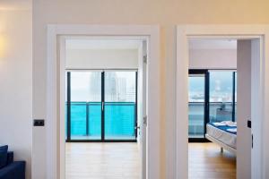 an open door to a room with a view at Orbi City Sea View Balcony ApartHotel in Batumi