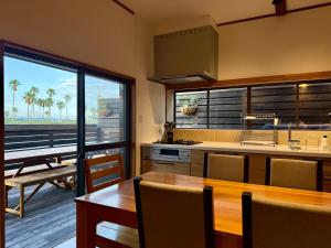 a kitchen with a table and a kitchen with a piano at 鴨川ビーチハウス in Kamogawa