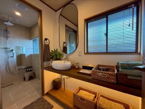 a bathroom with a sink and a shower at 鴨川ビーチハウス in Kamogawa +22 photos