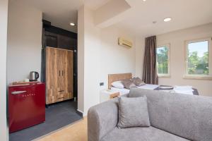 a living room with a couch and a bedroom at Marvera Hotel in Fethiye