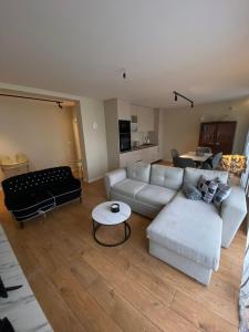 a living room with a couch and a table at Vi Lux Apartments in Visoko