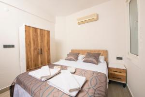 a bedroom with a bed with two towels on it at Marvera Hotel in Fethiye