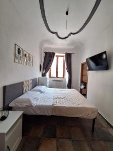 a bedroom with a bed and a tv on the wall at Casa Conti Trivelli in Vasto