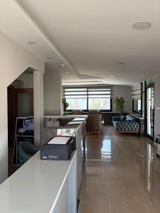 a kitchen and living room with a counter and a couch at Gölpark Otel in Yeniçağa