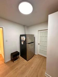 a room with a black refrigerator in the middle of a room at Treverton Retreat in Toronto +15 photos