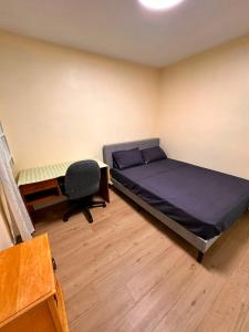 a bedroom with a bed and a desk and a chair at Treverton Retreat in Toronto