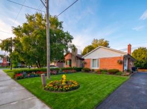 a house with a yard with a yellow fire hydrant at Treverton Retreat in Toronto