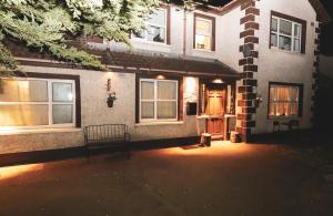 a bench in front of a house at night at Gra accommodations athy in Athy