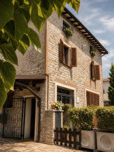 a brick building with windows and a gate at Casa Due Marie Boutique stay near Modena & Maranello in Marano sul Panaro