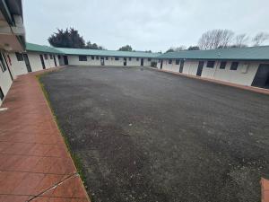 an empty parking lot in front of a building at Raceway Lodge in Feilding