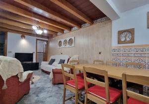 a living room with a table and a bedroom at Gran Areatxa Home Mountain in Santiago de la Espada