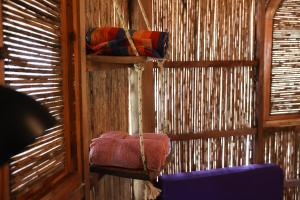 a room with a wooden wall with a swing at Adama Eco Farm in Santa Catalina