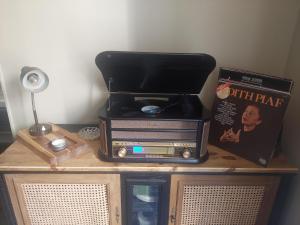 a table with a radio and a book on it at Près du Vicomte in Maincy