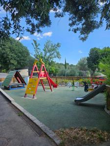 a playground with colorful play equipment in a park at Memita Mobile homes, Selce in Selce