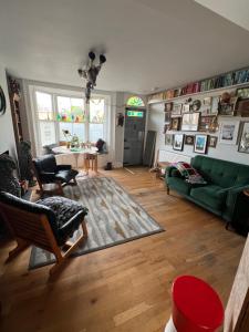 a living room with a green couch and a table at Rubber Chicken House - Ramsgate in Ramsgate