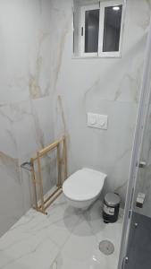 a white bathroom with a toilet and a mirror at Boeing AL Q1 in Moreira