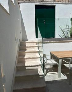 a stairway with a green door and a table at Apartment Dolce by DuBooker in Trpanj +10 photos