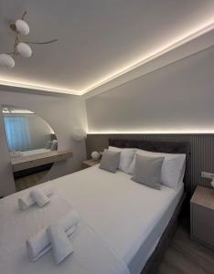 a bedroom with a large white bed with two pillows at Apartment Dolce by DuBooker in Trpanj