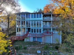 a large blue house on a hill with trees at Downtown Chantilly Ste Piedmont in Eureka Springs