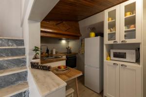 a kitchen with a white refrigerator and a counter at A casa da avó Tina in Montemor-o-Novo