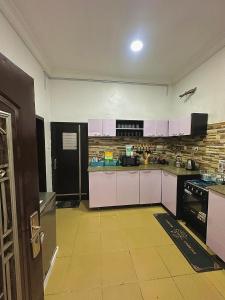 a kitchen with white cabinets and a counter top at Brainardville in Iseri