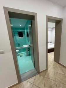 a bathroom with a glass shower with a sink and a toilet at Villa Merkaj in Sarandë +28 photos