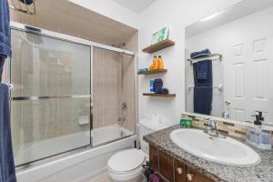 a bathroom with a toilet and a sink and a shower at Semi-Private Townhouse - 3 Bedrooms, 4 beds, Free Parking, Wifi, Netflix, - Hosted by Matthew in Toronto