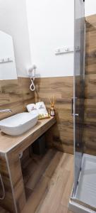 a bathroom with a sink and a shower at S'apposentu 'e Santa Ruche in Oniferi