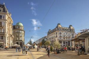 a group of people walking on a city street at Chambre C room in Biel