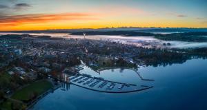 an aerial view of a city with fog on the water at Chambre C room in Biel