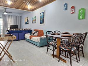 a living room with a table and chairs and a couch at Paraíso em Juquehy in Juquei +28 photos