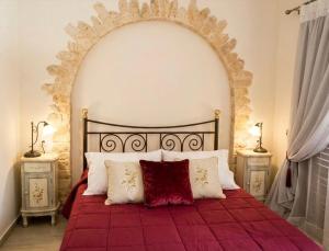 a bedroom with a large bed with a red blanket at Dreamcatcher Maisonette No.2 in Kalavrita