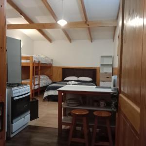 a room with a kitchen and a bedroom with a bed at Ruta 7 in Coihaique +6 photos