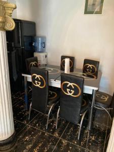 a kitchen with a table with chairs with skulls on them at Rashlie apartment in Freetown