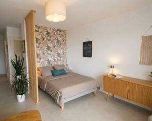 a small bedroom with a bed and a dresser at Seaview.Cassis in Cassis