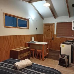 a room with a table and a kitchen with a table and chairs at Ruta 7 in Coihaique