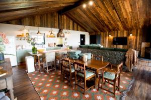 a kitchen and living room with a table and chairs at Oak - The Nook Lodges in Wrenbury