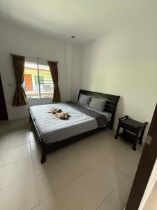 a bedroom with a bed in a room with a window at olivia village pool resort in Mae Nam +31 photos