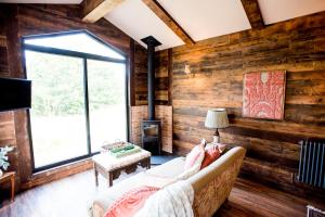 a living room with a couch and a fireplace at Clover in Wrenbury