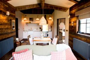 a living room with a couch and a table at Clover in Wrenbury